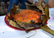 Pib! Like a large tamal, but the best one you'll ever taste. Cooked underground wrapped in banana leaves....